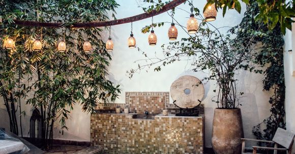 Wellness Gardens - Traditional oriental hammam pool on exotic resort spa terrace decorated with lush plants and stylish lanterns